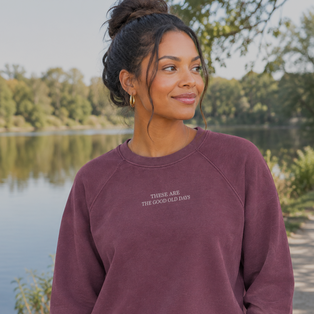 Woman wearing the These Are the Good Old Days luxe terry crew, a lightweight french terry crew with These Are the Good Old Days’ design printed subtly near the collar on the front.