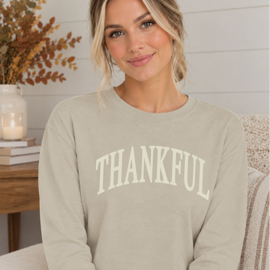 Woman wearing a premium long sleeve shirt featuring a large “thankful” graphic across the front from Branded & Labeled