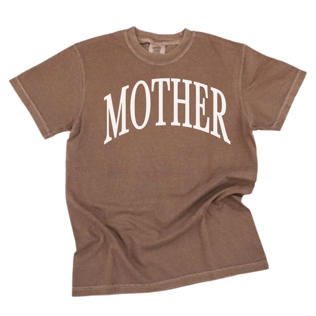Adult premium tee featuring oversized “MOTHER” text in a classic serif font, clean and elevated design.