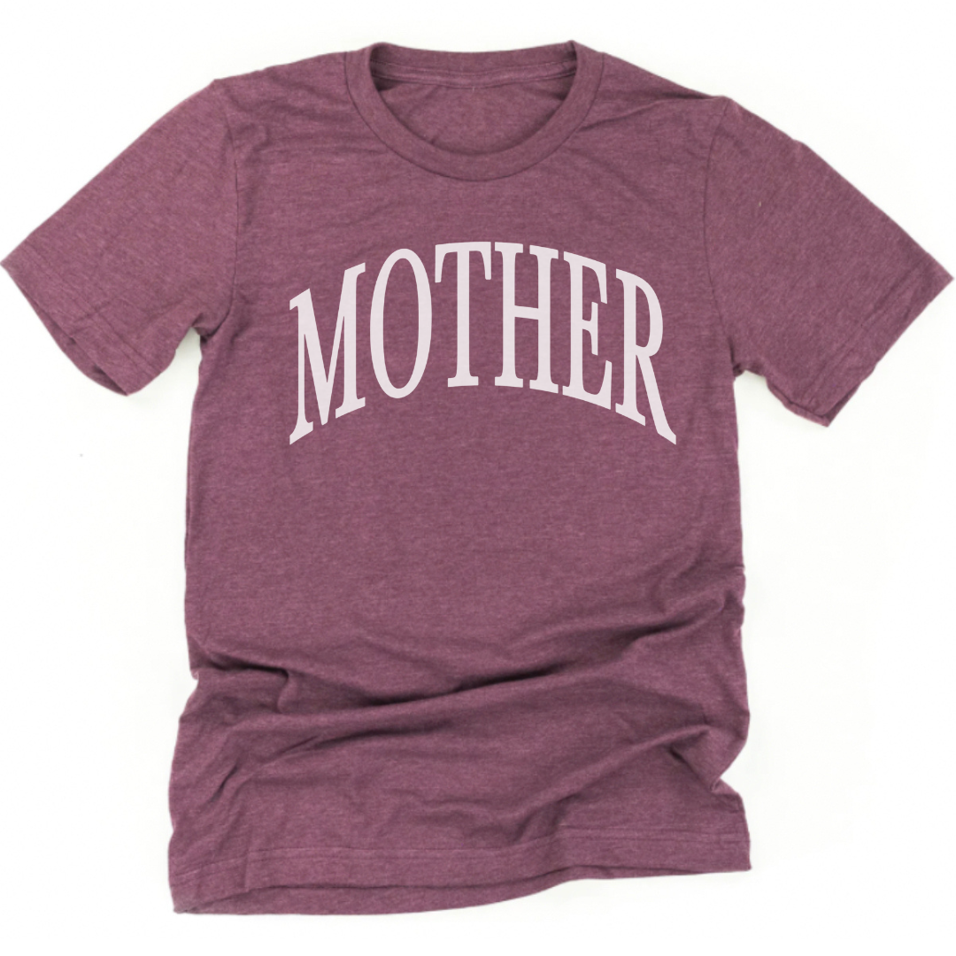 Adult everyday tee featuring oversized “MOTHER” text in a classic serif font, clean and elevated design.