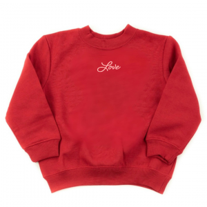 flat lay image of a kids red fleece sweatshirt with the word "Love" in a cursive script font in pink ink printed subtlety on center chest right below the collar