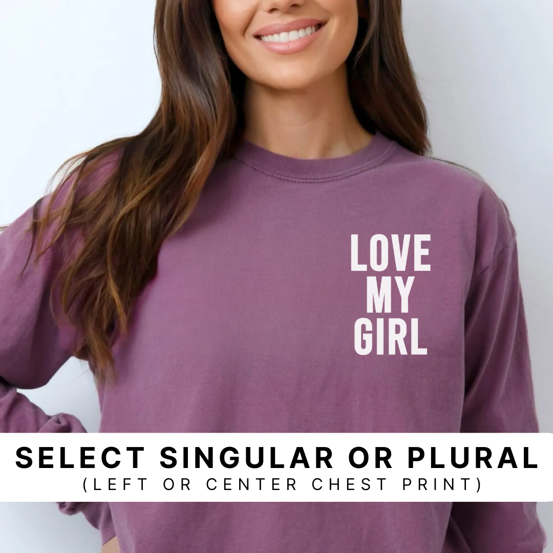 berry colored garment-dyed premium long sleeve featuring the “Love My Girl” design in white ink printed on the left chest, with a banner indicating options to choose singular or plural wording and left or center chest print placement.