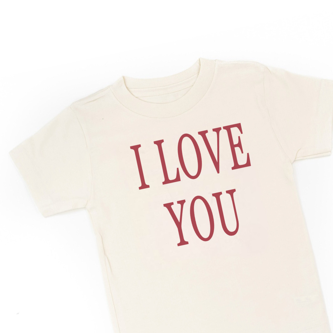 flat lay image of a kids natural colore tee with the "I love you" graphic design
