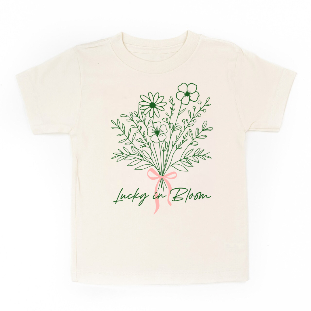 kids natural colored short sleeve tee with a floral bouquet and text that reads "Lucky In Bloom"