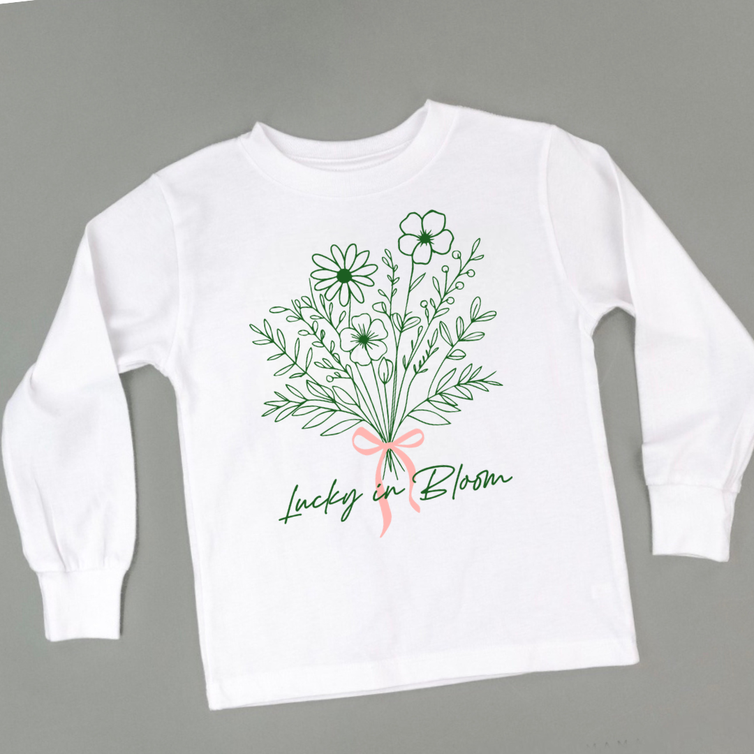 kids white long sleeve tee with a flower bouquet and the text "Lucky In Bloom"