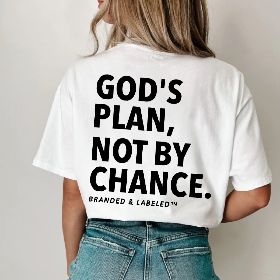 Woman modeling a white Branded & Labeled graphic tee with "God's Plan Not By Chance" printed boldly