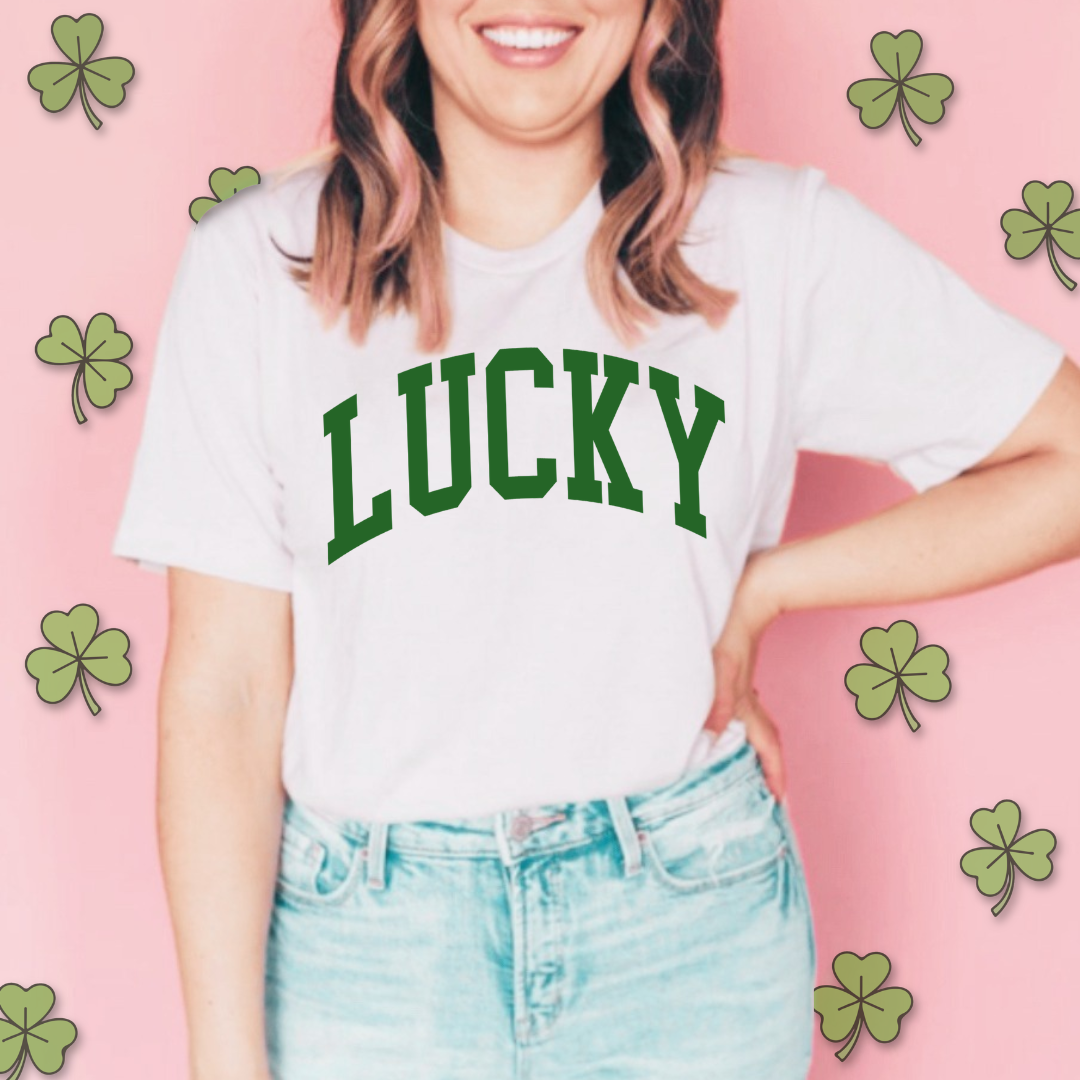 woman modeling white everyday tee with "Lucky" in a bold varsity styled font across the front