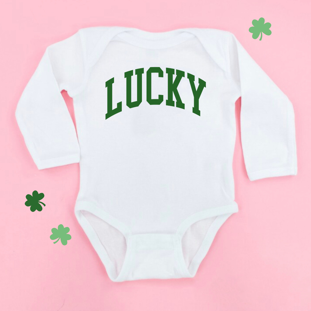 infant white long sleeve bodysuit with "Lucky" in a bold varsity style font in green across the front