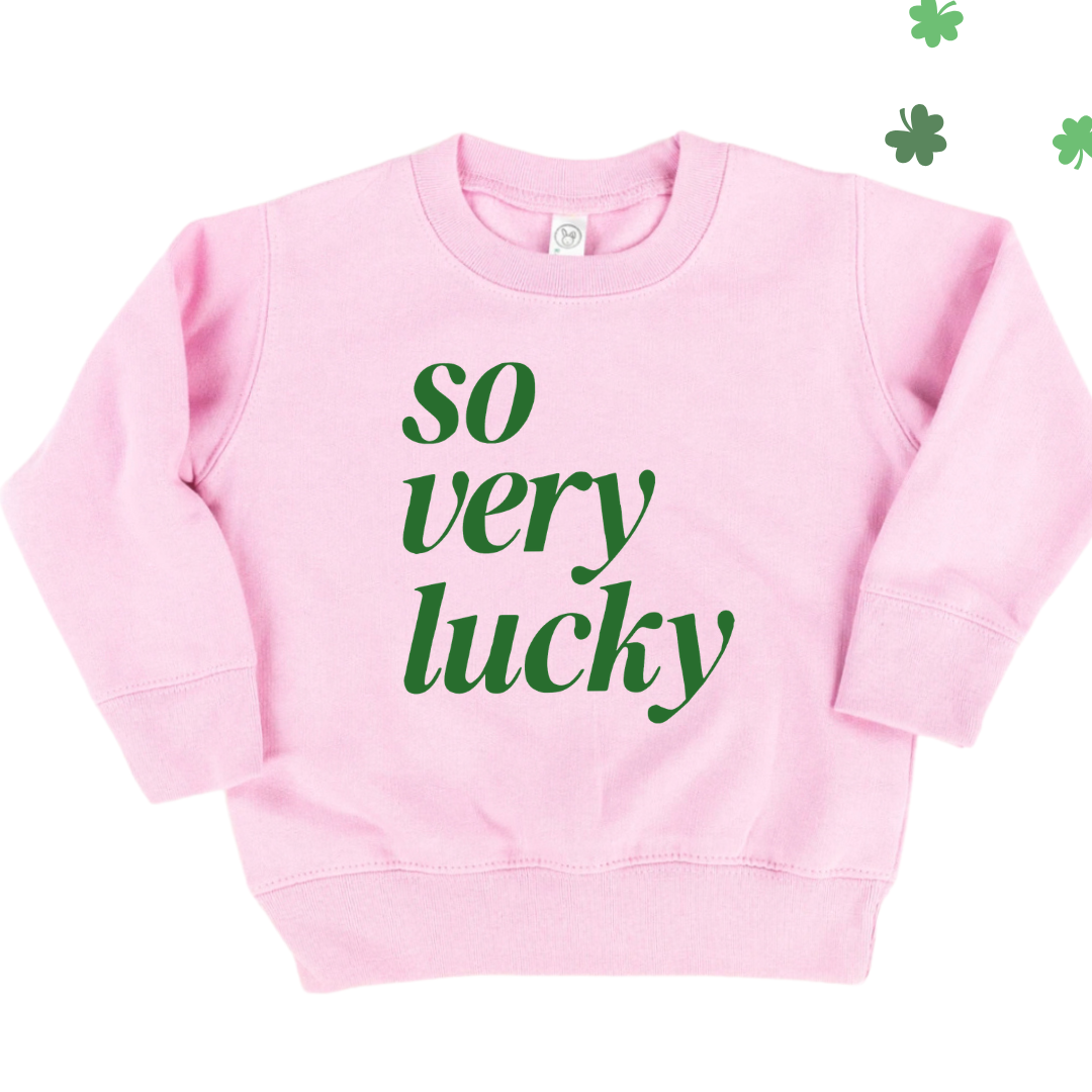 kids pink fleece pullover with "So Very Lucky" in green printed on the front