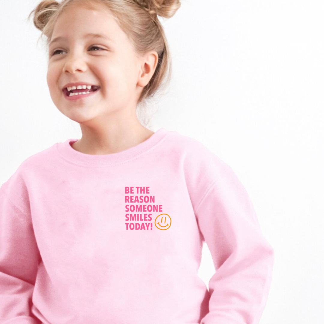 Kids fleece pullover showing the front design “Be the Reason Someone Smiles Today” from Branded & Labeled.