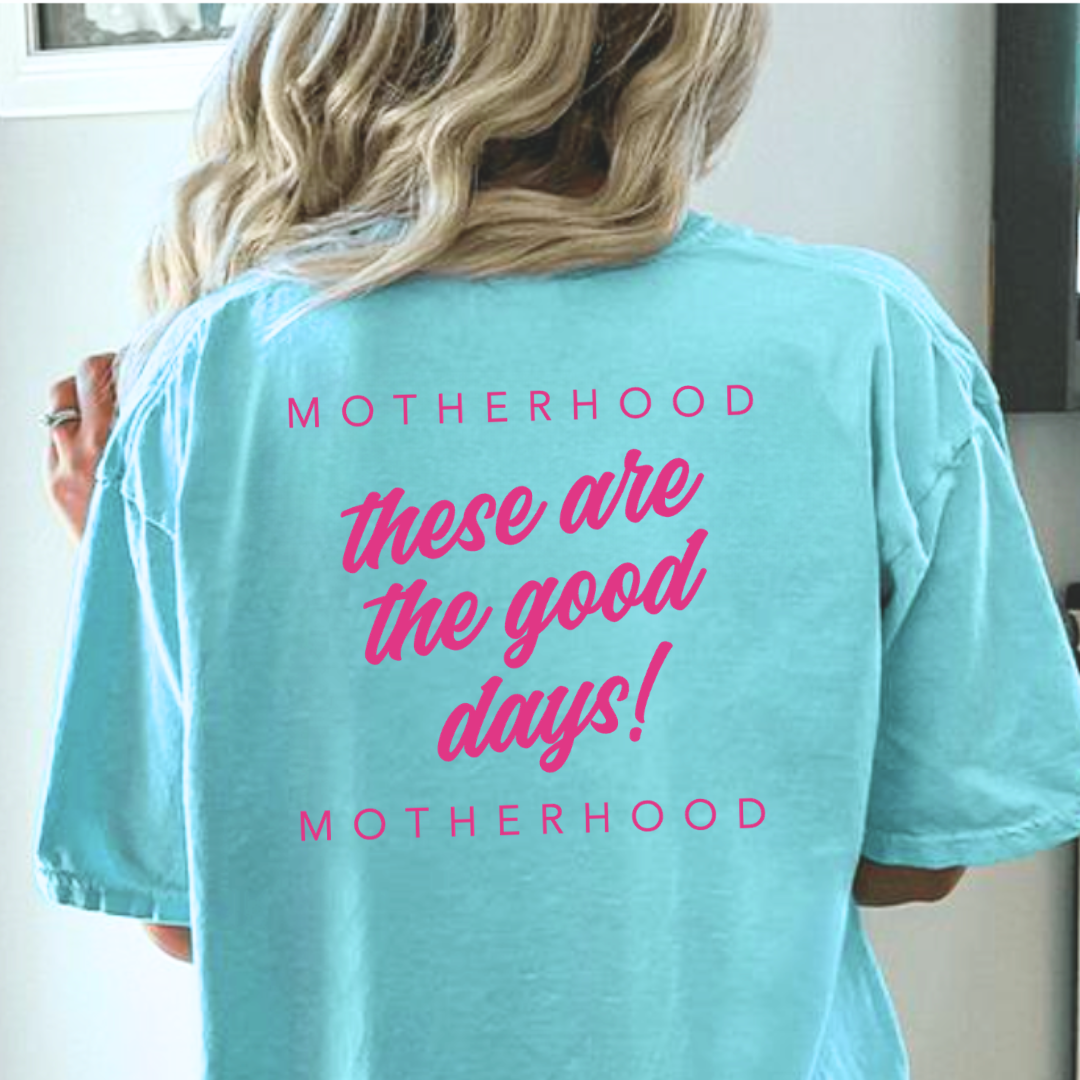Woman modeling the adult graphic tee featuring the phrase “These Are the Good Days: Motherhood” printed on the design from Branded & Labeled.