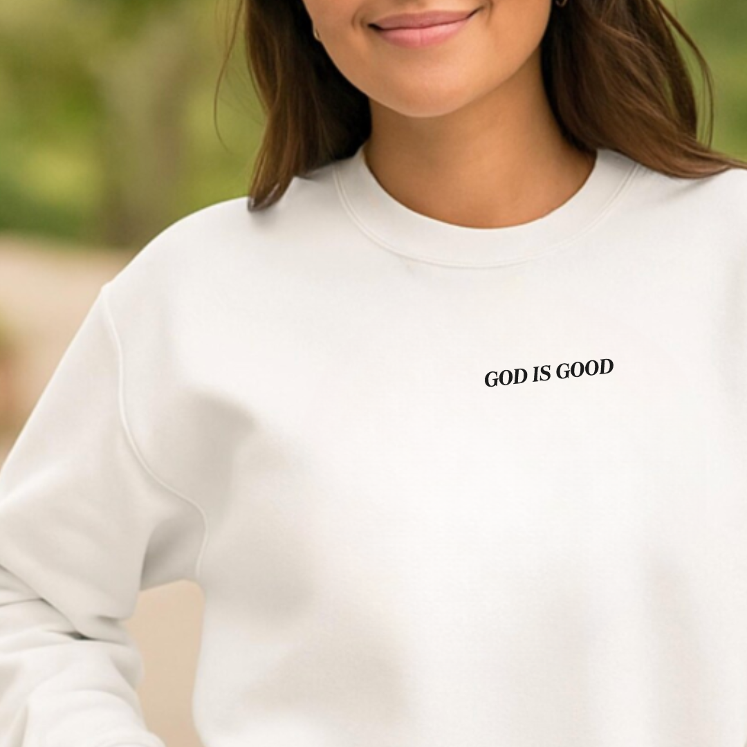Woman modeling the Adult fleece pullover featuring the phrase “God Is Good” printed on the front from Branded & Labeled.