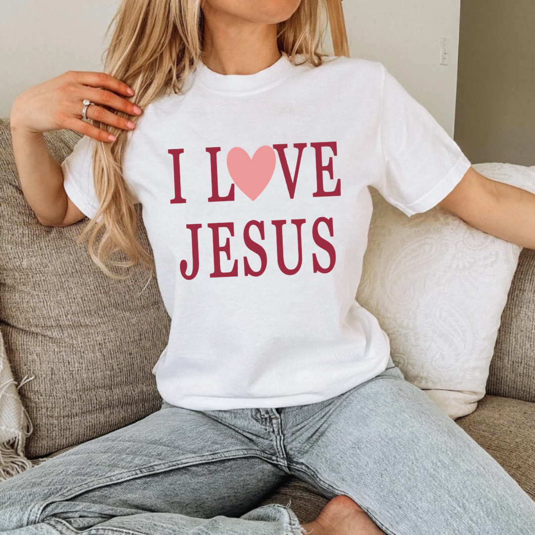 Woman modeling a white Christian graphic tee that reads “I Love Jesus,” part of the Branded & Labeled inspirational apparel.