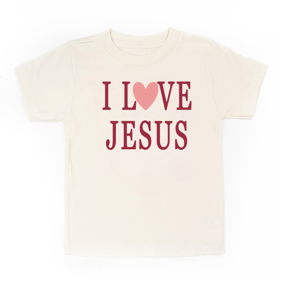 Kids natural colored graphic tee featuring the phrase “I Love Jesus” printed on the front, a Christian faith-based kids shirt from Branded & Labeled.