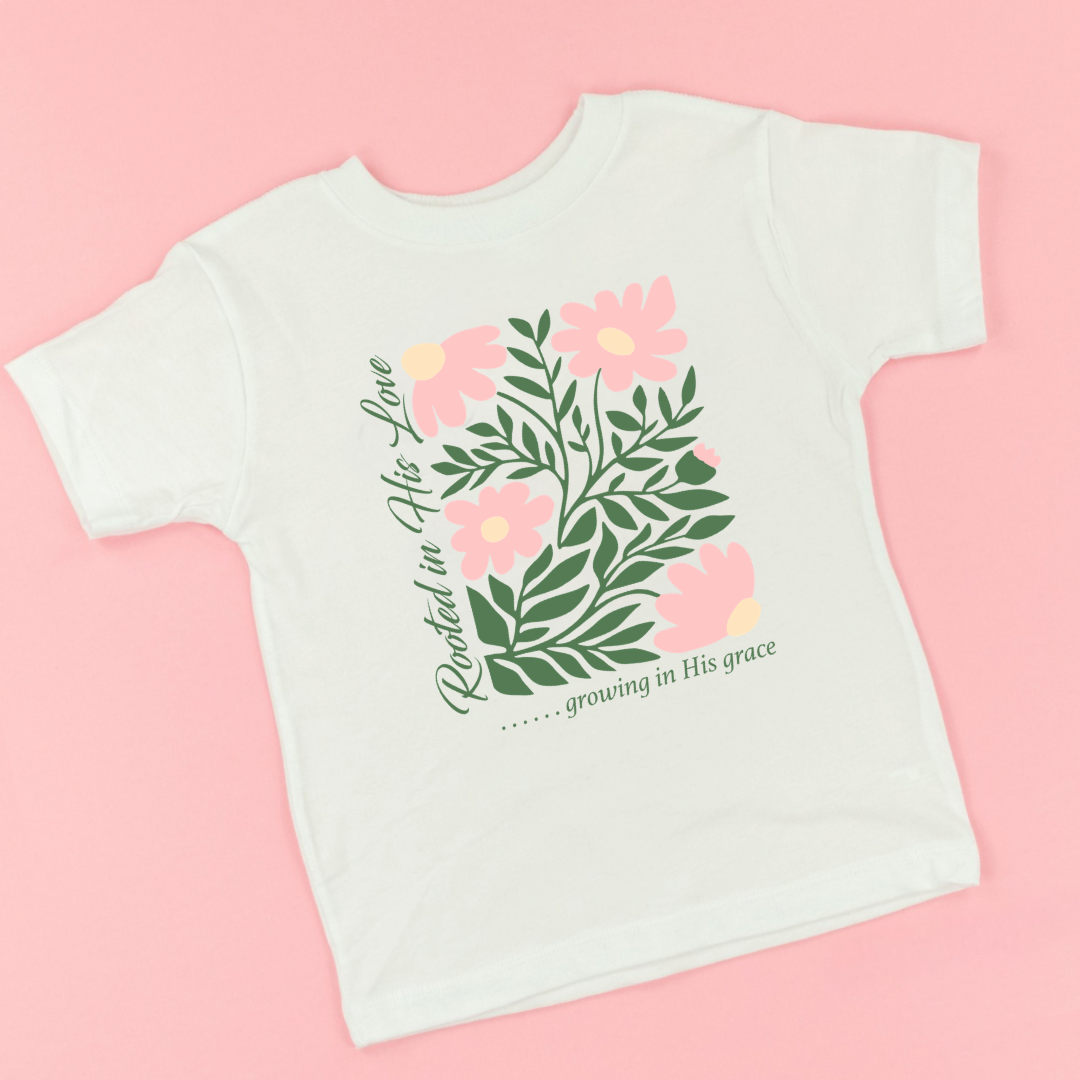 Kids natural colored graphic tee featuring the phrase “Rooted in His Love, Growing in His Grace” printed on the front, a Christian faith-based kids shirt from Branded & Labeled.
