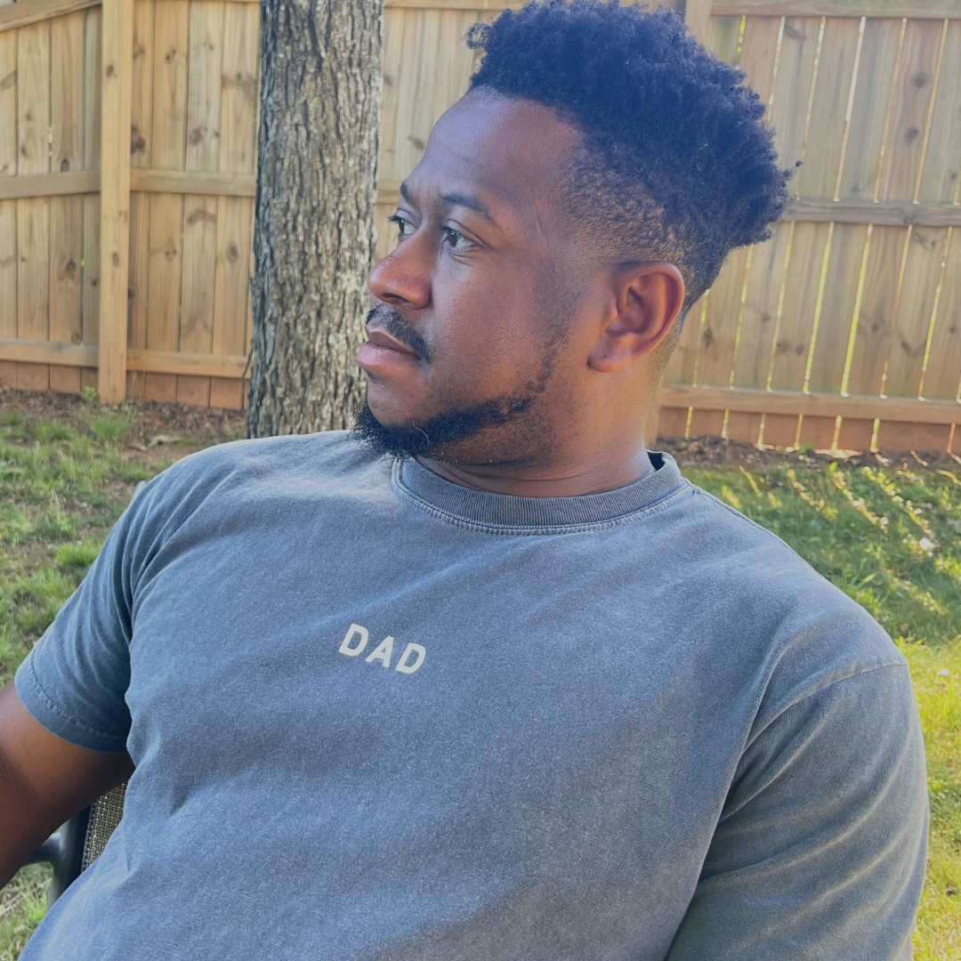 Premium adult tee with Dad subtly printed near the collar