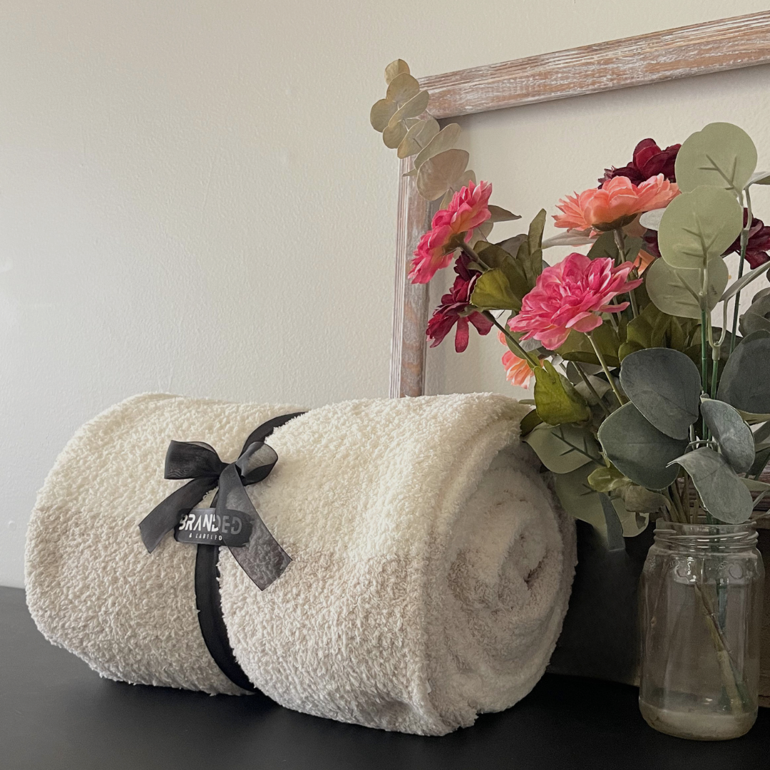 Signature Branded & Labeled soft knit throw blanket styled in a cozy home setting, designed for warmth and comfort