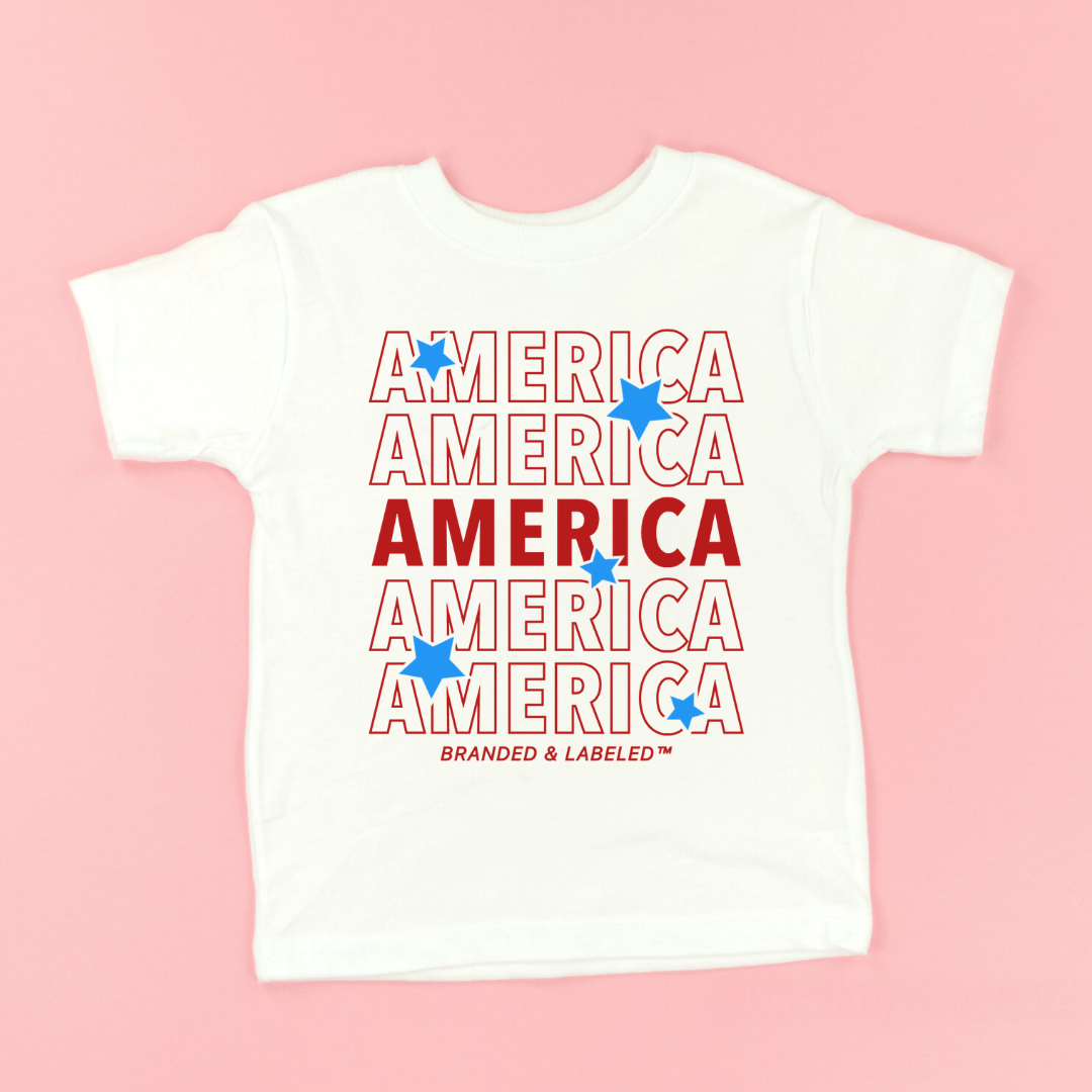 Kids graphic tee featuring repeating “America” text with playful stars in a patriotic-inspired design, part of the American Classics Collection by Branded & Labeled.
