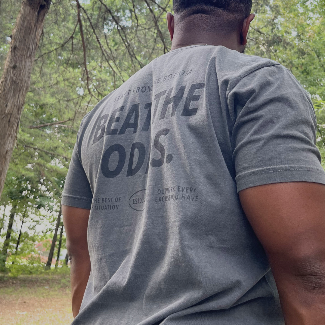 Man wearing the Beat the Odds premium graphic tee from Branded & Labeled's The Next Chapter collection.