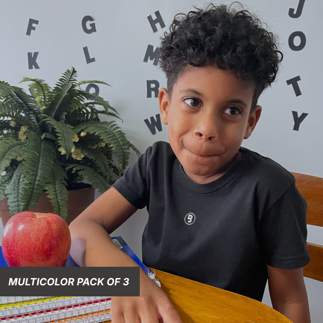 Child wearing the black Everyday Essentials: Classic Collection premium kids tee featuring the subtle Branded & Labeled signature logo printed near the front collar.