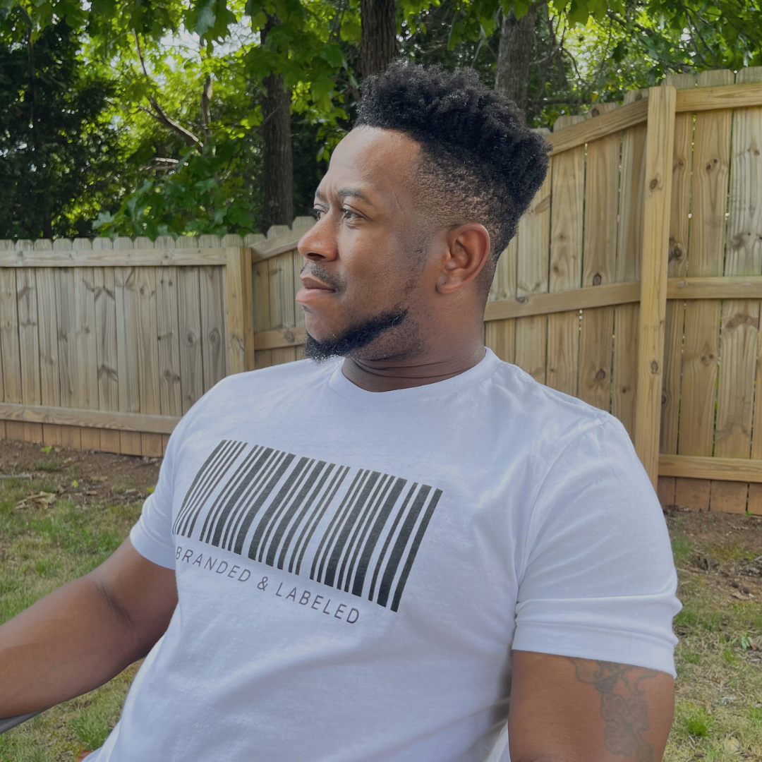 Man wearing The Identifier adult everyday tee from Branded & Labeled featuring a barcode-inspired graphic on the front.