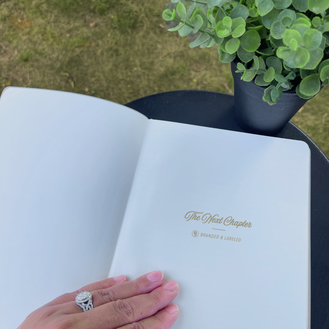 Light gray B5 size journal with a premium cover featuring “The Next Chapter” in shimmer gold lettering and “Branded & Labeled” printed underneath.